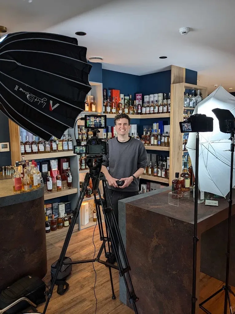 Jack setting up a YouTube shoot in a whisky shop